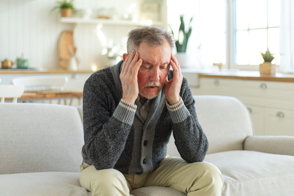 homme senior ayant des maux de tête 
